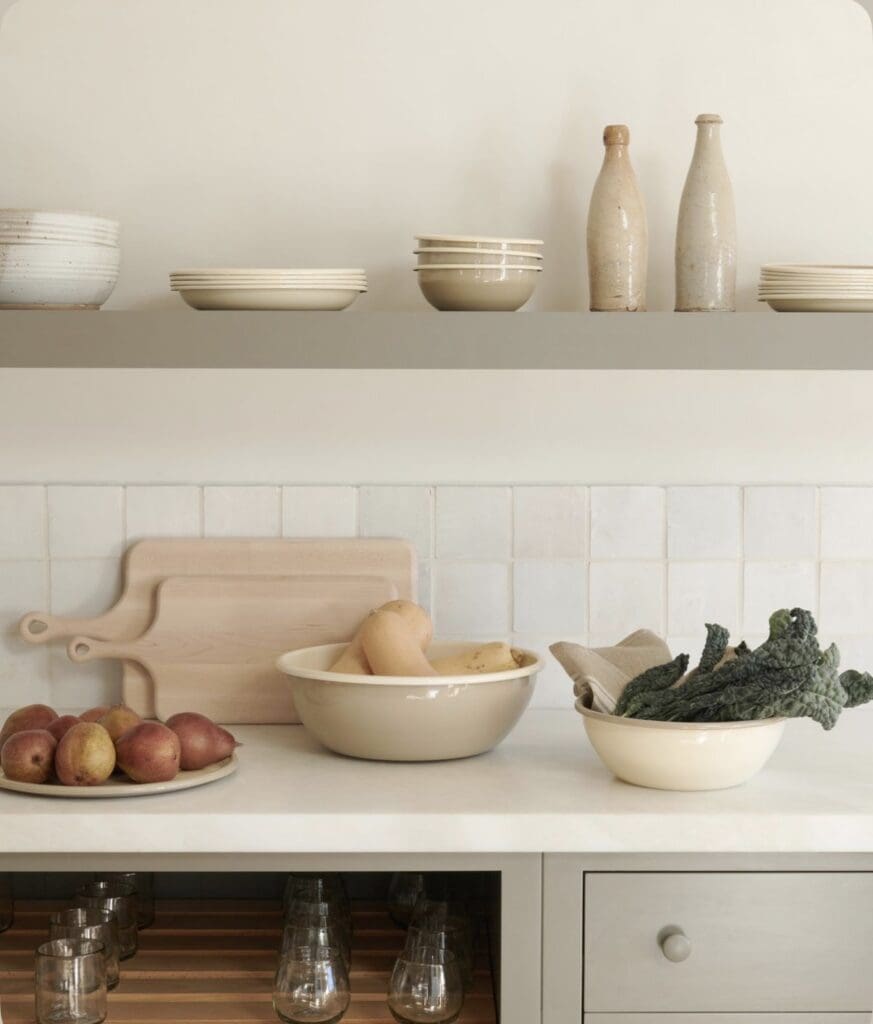 Kitchen inspiration: open shelving with cream stoneware and ceramics for a red brick cottage